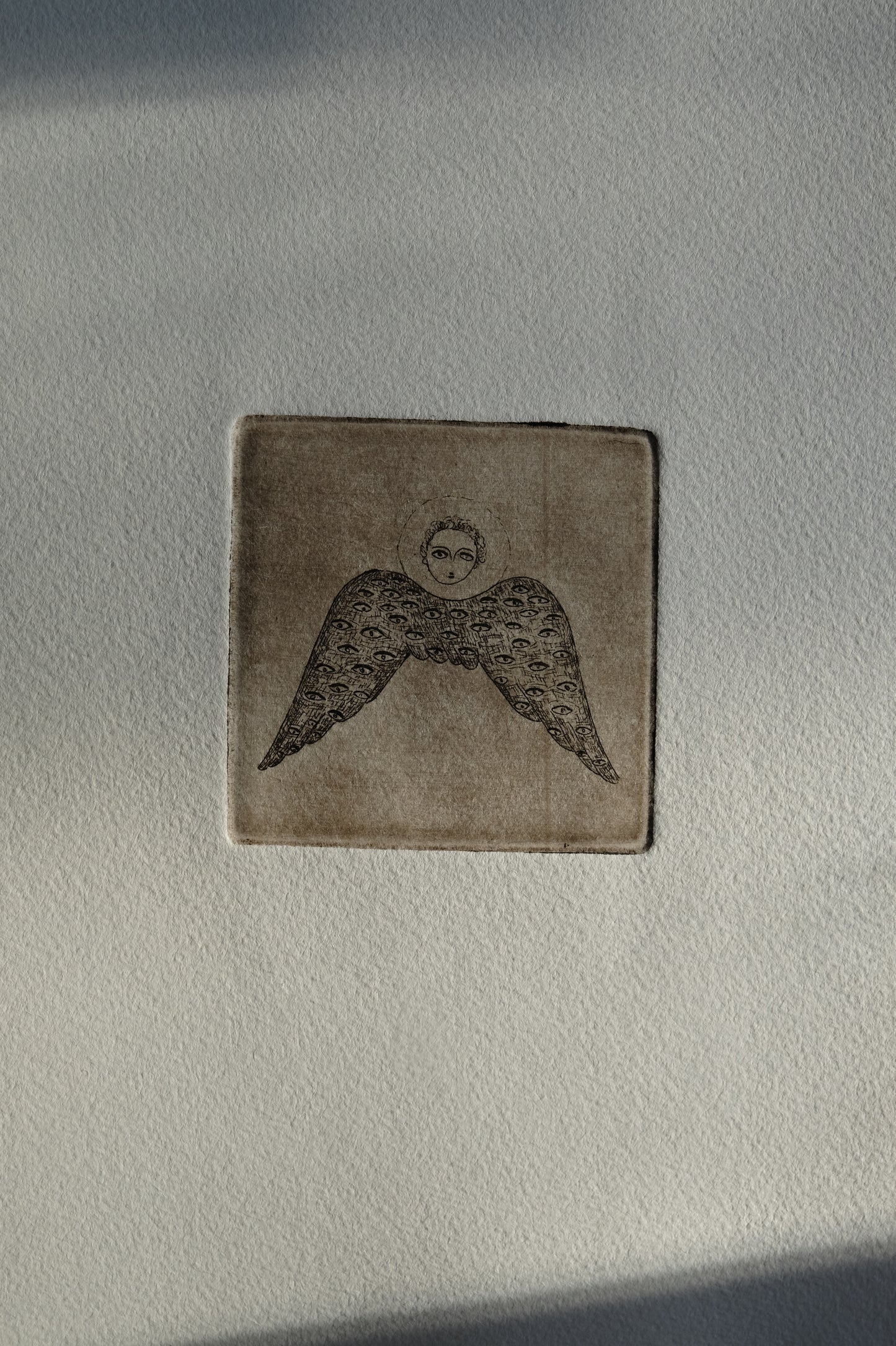 Angel with eyed wing